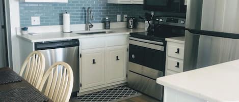 Kitchen with new appliances and backsplash