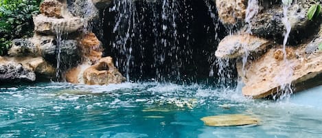 Grotto pool with waterfall and swim in cave
