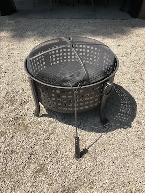 Fire pit area includes a rack for grilling 