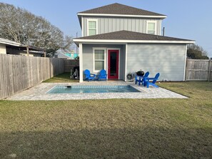 Spacious fenced in backyard with heated pool