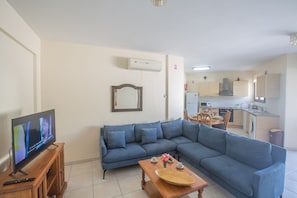 Living room with comfortable corner sofa and widescreen TV