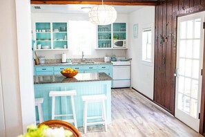 The light blue kitchen is so quaint and fun to cook in!