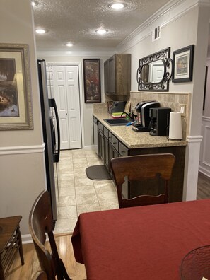 Galley kitchen w/ Keurig & drip coffee maker, toaster oven, air fryer & blender.