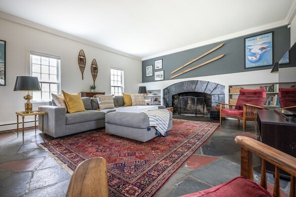 Expansive ski-themed living room with large fireplace