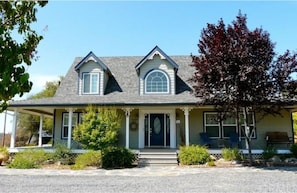 Front entrance with an expansive deck with seating to enjoy your morning drink.