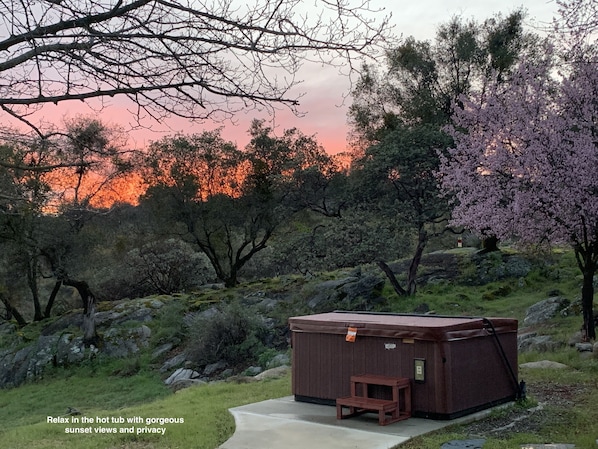 Soak in a secluded hot tub with expansive views and stunning sunsets.