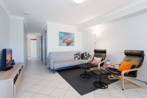 Rear TV room adjoining dining area.