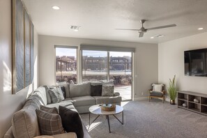 Living Room View of Pool - The living room has a beautiful view of the pool amenity.