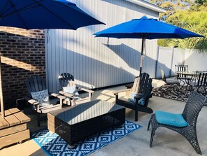 Private fenced-in patio w/ umbrellas and charcoal grill 