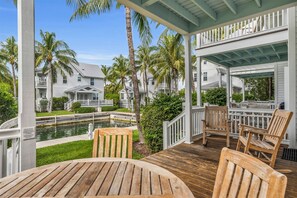 Lower level canal side porch with seating: perfect for your morning coffee