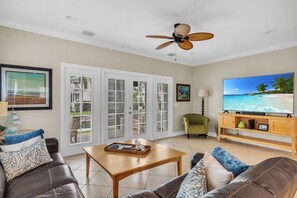 Living room area with leather couch and TV