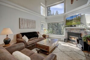 Beautiful living area with gas fireplace, flatscreen TV, and tons of natural light.