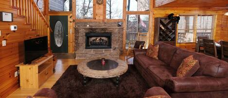gas log grand fireplace to warm you while relaxing on the sofas