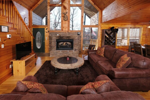 gas log grand fireplace to warm you while relaxing on the sofas