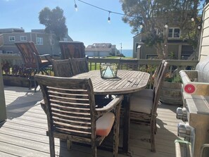 Ocean facing deck  w/ 4 bar height swivel chairs, table for 6, & bbq