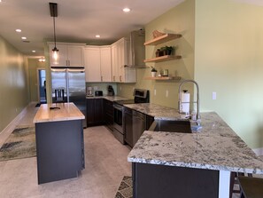 Farmhouse sink, peninsula seating for three, tons of storage!