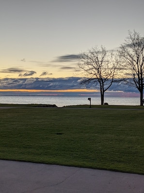 Lawn before beach and fire pit by lake