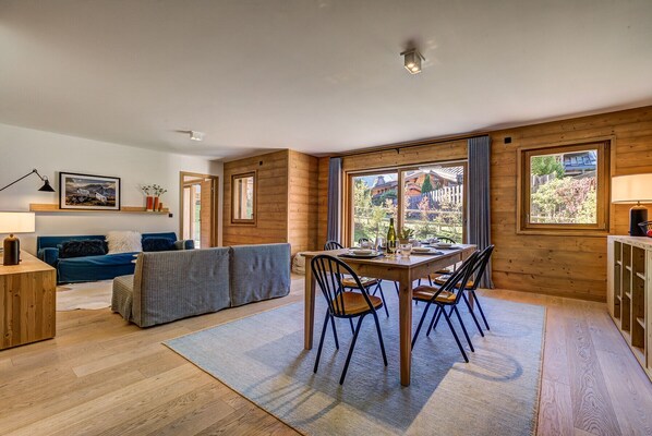 Dining table sits in front of large glass doors
