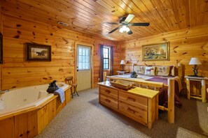 owner's suite with king bed, jacuzzi tub, and a private deck 