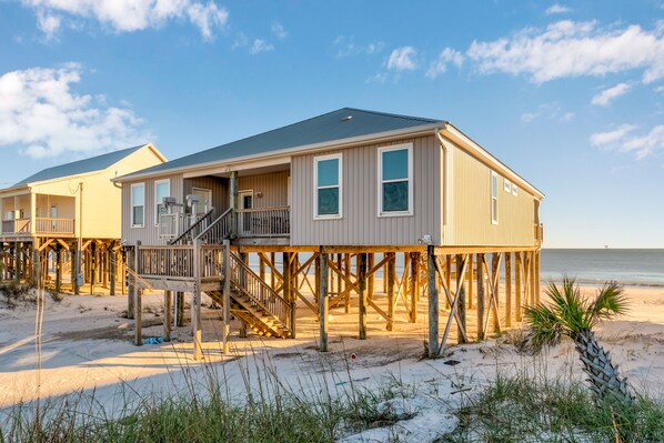 Dauphin Island Real Estate gulf front paradise vacation rental. Exterior view of the home and the beach.