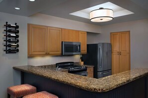 Full Kitchen with Refrigerator, Microwave, Stove/Oven, Dishes and Utensils.