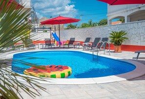 Heated pool with sunloungers