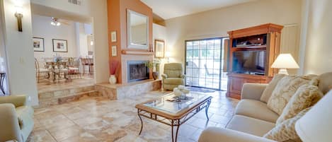 Living room: Vaulted ceiling with fireplace.   Apple TV, cable, DVD, & stereo. 