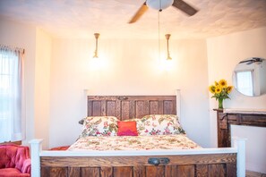 The king bed has been repurposed from antique oak doors. 