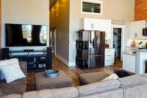 Looking from common area west towards the 1/2 bath, bedroom, laundry room and entrance door.
