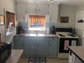 Kitchen includes brand new toaster, coffeepot, and microwave. 