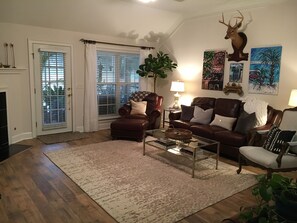 Great room with leather sofa and chair. "See Dog" guards the space from above!