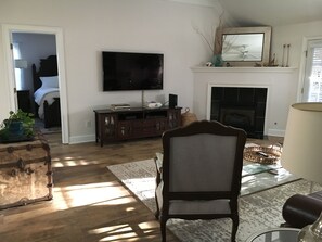 Large screen TV with Xfinity and a gas fireplace in the great room.