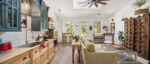 Kitchen with full sized refrigerator, dishwasher and range. 