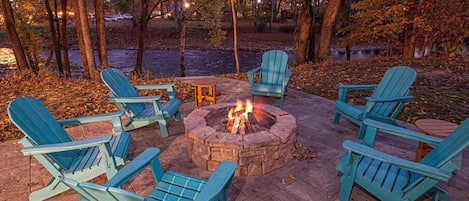 Cozy fire pit by the river on a beautiful fall evening.