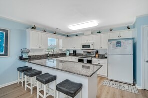 Kitchen is complete with bar seating to enjoy great company