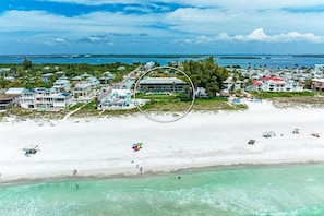 Aerial view over the Gulf looking at the condo building for Sunset Beach 102