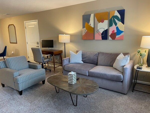 Spacious open floor plan with comfortable furniture and lots of natural light. :) 