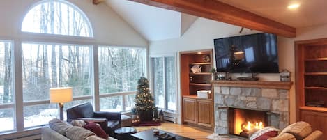 Inviting, open concept family room with gas fireplace and 65" flat screen tv