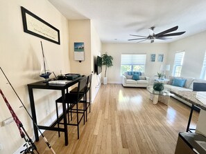 Spacious living room with high top desk.