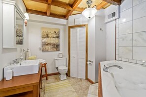 Beautifully tiled full bathroom with rain shower.