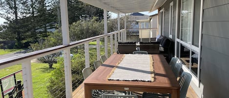 Outdoor dining with sunny ocean outlook.