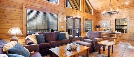 Spacious open concept living w/floor-to-ceiling windows & wrap around porch
