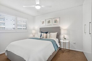 The main bedroom has a queen bed with bamboo mattress topper & lots of storage