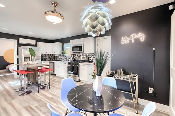 Fully Equipped Kitchen With Open Concept Design, Island, And Unique Lighting Features