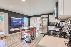 Spacious Kitchen With Stainless Steel Appliances, Center Island, And Smart TV For Entertainment
