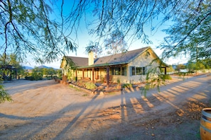 Mesquite trees line the walkway next to the Cottage