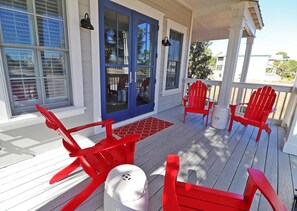 The front porch of this luxury home is perfect for morning coffee or an cool afternoon beverage!