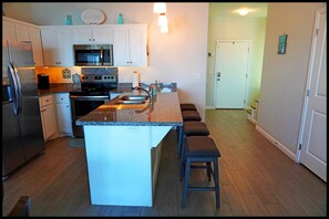 Kitchen with full appliances and 4 person bar/breakfast counter