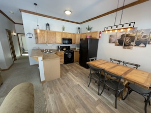 10 ft ceilings! Nice and spacious kitchen stocked with cooking utensils.