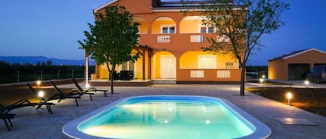 Exterior with pool at night